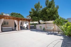 a patio in a villa with trees at Artemis Boutique House in Artemida
