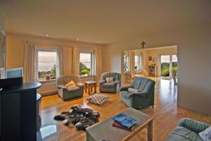 a living room with two chairs and a table at 3 Bed in Inch oc-i444 in Caheracruttera