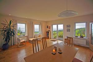 a living room with a table and chairs and windows at 3 Bed in Inch oc-i444 in Caheracruttera