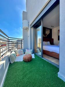 a balcony with a room with a bed and a couch at Arena Maarif 41 in Maarif