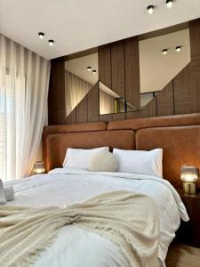 a bedroom with a large bed with white sheets at Arena Maarif 41 in Maarif