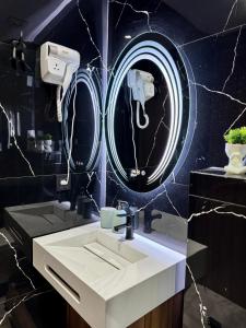 a bathroom with a white sink and a mirror at Arena Maarif 41 in Maarif +118 photos