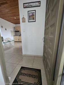 a hallway with a door and a rug on the floor at Luxury flandes in Flandes