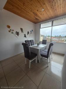a dining room with a table and chairs and a window at Luxury flandes in Flandes