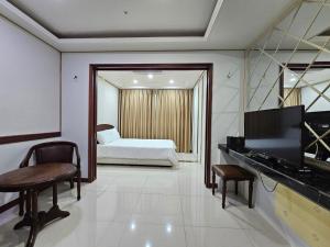 a room with a bed and a television and a bedroom at 인터시티365호텔 in Seoul