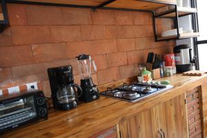 a kitchen counter with a stove and a blender at Hotel Ladrillo in Oaxaca City