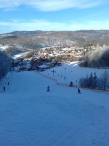 a group of people skiing down a snow covered slope at Privát Miško in Levoča