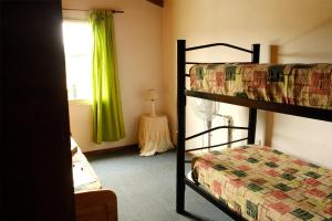 a bedroom with two bunk beds and a window at Cabañas Yunyay in Villa Cura Brochero +17 photos