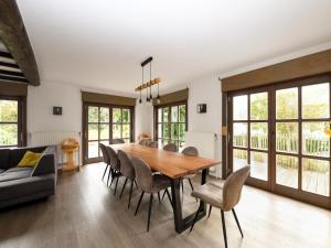 a dining room with a wooden table and chairs at Floribert in Nieuwpoort-Bad