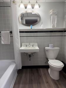 a bathroom with a sink and a toilet and a mirror at Bucksport Inn in Bucksport +43 photos