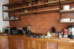 a counter in a kitchen with a brick wall at Habitación arroqueño in Oaxaca City