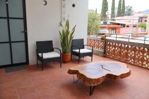 a patio with a table and two chairs and a table at Habitación arroqueño in Oaxaca City