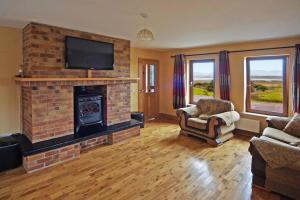 a living room with a brick fireplace with a tv at 4 Bed in Inch oc-i190 in Anascaul