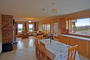 a kitchen and living room with a table and chairs at 4 Bed in Inch oc-i190 in Anascaul