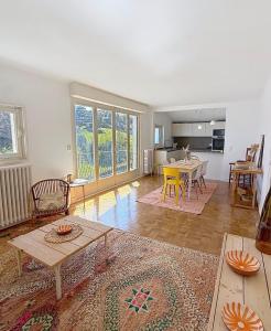 a living room with a table and a dining room at Socoa vue mer in Ciboure