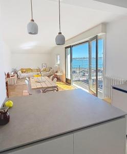 a kitchen and living room with a view of the ocean at Socoa vue mer in Ciboure