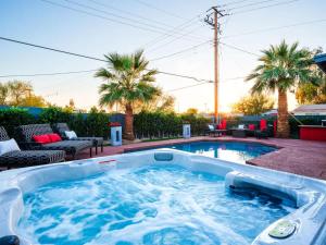 a hot tub in a backyard with palm trees at Modern Roose-Private Pool-In Old Town Scottsdale in Scottsdale