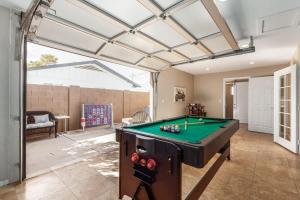a living room with a pool table in it at Games Galore - Old Town Scottsdale - Pool & Golf in Scottsdale