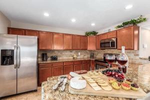 a kitchen with a table with glasses of wine and cheese at Games Galore - Old Town Scottsdale - Pool & Golf in Scottsdale
