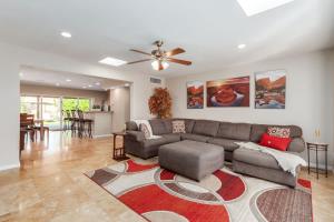 a living room with a couch and a ceiling fan at Games Galore - Old Town Scottsdale - Pool & Golf in Scottsdale