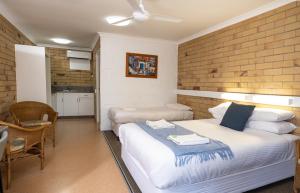 a bedroom with a bed and a table and chairs at Farview Tavern in Farleigh