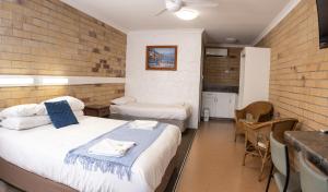 a room with two beds and a table and chairs at Farview Tavern in Farleigh