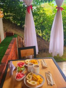 a table with plates of food on top of it at Quinta La Primavera Ecolodge in Isnos