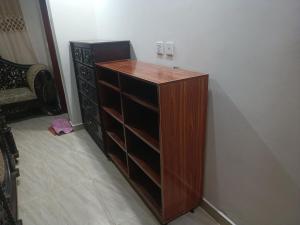 a wooden cabinet with empty shelves in a room at Call it a home in Rawalpindi