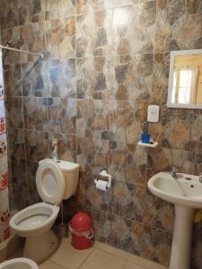 a bathroom with a toilet and a sink at Vista del Plata - Alojamiento in Potrerillos +17 photos