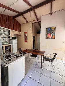 a kitchen with a table and a stove top oven at Mama Cat's Accommodation in Avarua