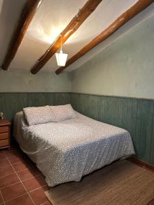 a bedroom with a bed in a green wall at Casa Castillo in Moratalla +4 photos