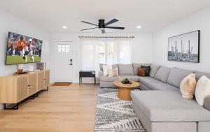 a living room with a couch and a ceiling fan at Sweet Serenity-Private Pool-8 Mins to Old Town in Scottsdale