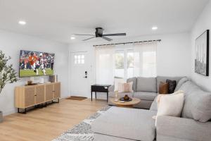 a living room with a couch and a tv at Sweet Serenity-Private Pool-8 Mins to Old Town in Scottsdale
