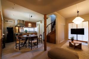 a kitchen and living room with a table and chairs at kobito in Toyama