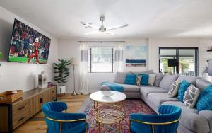 a living room with a couch and a table and chairs at Old Town Art Deco - Pool&Fire Pit - In Old Town in Scottsdale