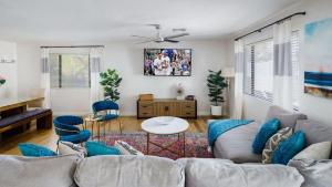 a living room with a couch and a table at Old Town Art Deco - Pool&Fire Pit - In Old Town in Scottsdale +65 photos