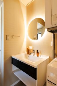a bathroom with a sink and a mirror at kobito in Toyama +28 photos