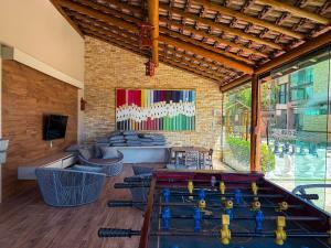 a living room with a pool table and a room with chairs at Villas de Samoa - House with 4 bedrooms in Cabedelo