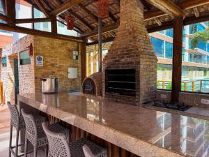 an outdoor bar with a brick oven in a building at Villas de Samoa - House with 4 bedrooms in Cabedelo
