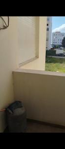 a window in a room with a ottoman in front of it at بوخالف طنجة Youssef Residence in Tangier
