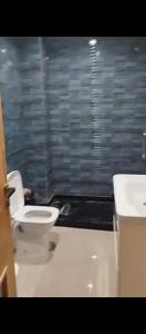 a bathroom with a toilet and a sink at بوخالف طنجة Youssef Residence in Tangier +9 photos