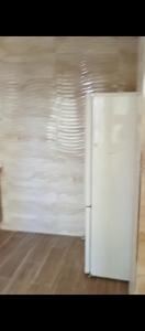 a white refrigerator in a room with a wall at بوخالف طنجة Youssef Residence in Tangier