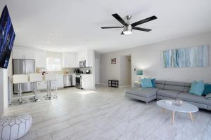 a living room with a couch and a ceiling fan at Casa Con Casita - Private Pool - 8 min to Old Town in Scottsdale