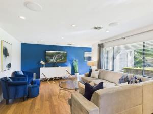 a living room with a couch and blue walls at Azure - Sparkling Pool - Pool Table - In Old Town in Scottsdale