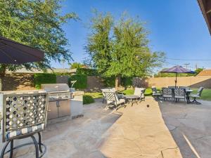 a patio with a grill and tables and chairs at Azure - Sparkling Pool - Pool Table - In Old Town in Scottsdale
