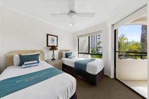 a bedroom with two beds and a large window at Spinnaker Quays in Mooloolaba +201 photos