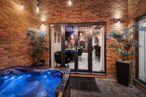 a hot tub in a room with a brick wall at 4 Bed in Morpeth oc-93775 in Thropton