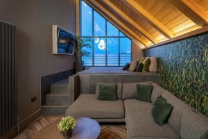 a living room with a couch and a large window at 4 Bed in Morpeth oc-93775 in Thropton