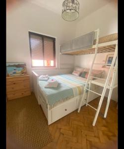 a bedroom with two bunk beds and a dresser at Quinta das Rosas - Beach 500m away in Figueira da Foz