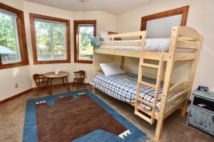 a bedroom with bunk beds and a table at Bearadise by Casago McCall - Donerightmanagement in McCall